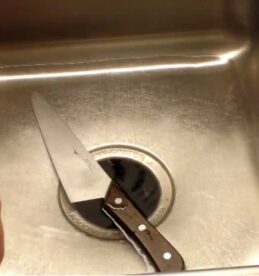 cleaning a knife in the sink