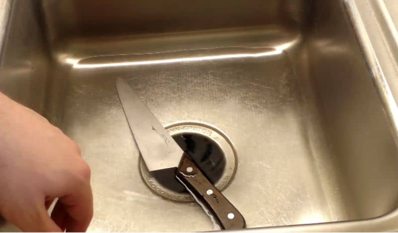 cleaning a knife in the sink