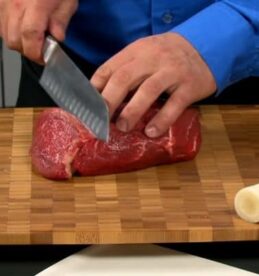 cutting meat with santoku knife
