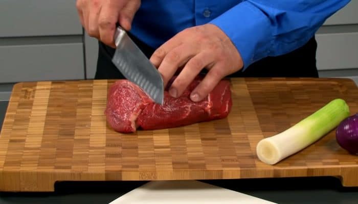 cutting meat with santoku knife