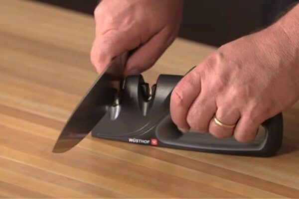 sharpening the knife with a knife sharpener