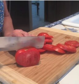 cutiing tomatoe with the vegetable knife