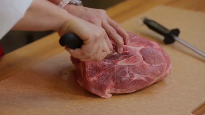 cutting meat with a boning knife