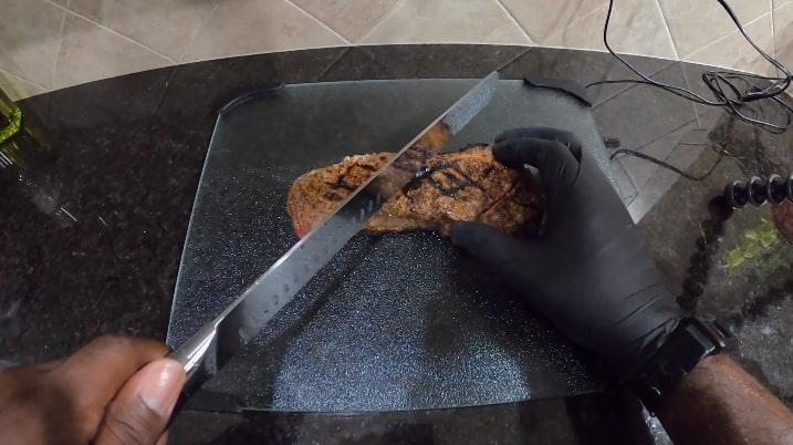 cutting meat with slicing carving knife