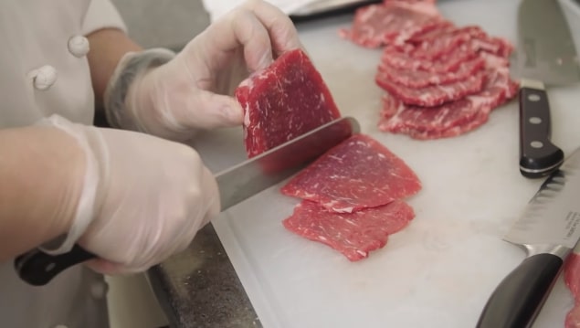 slicing meat with santoku knife