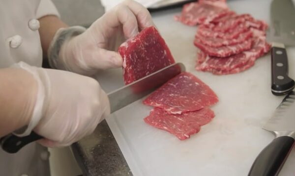 slicing meat with santoku knife